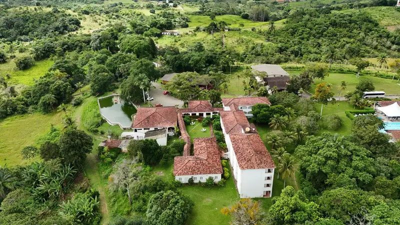 Aerial shot showcasing vibrant green landscape and rustic architecture in Moreno, Pernambuco, Brazil.