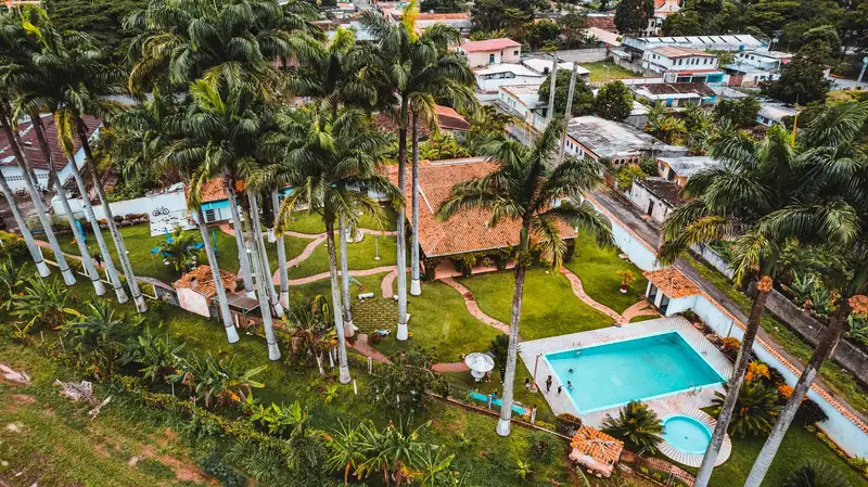 A stunning aerial shot of a tropical resort featuring lush palms and a sparkling swimming pool in Yaracuy, Venezuela.